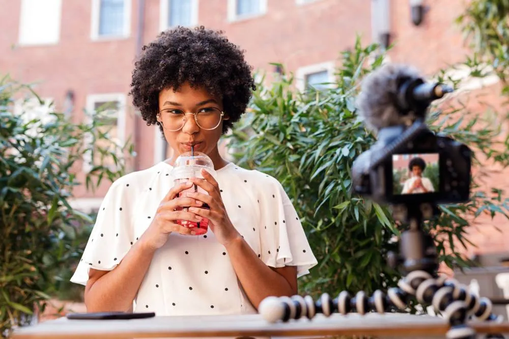 girl drinking juice while making content for a video