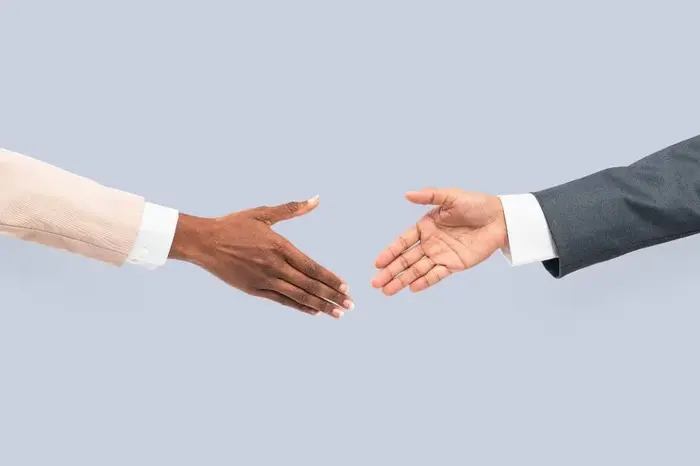 Two business professionals shaking hands after reaching an agreement