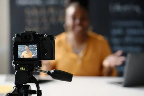 Presenter recording educational content on camera